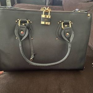 Black satchel with lock and key